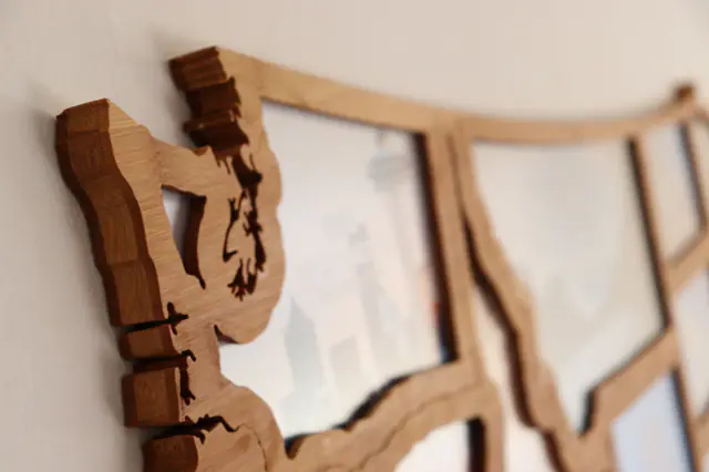 Borderframes on a wall, seen from the side with the bamboo edges in focus